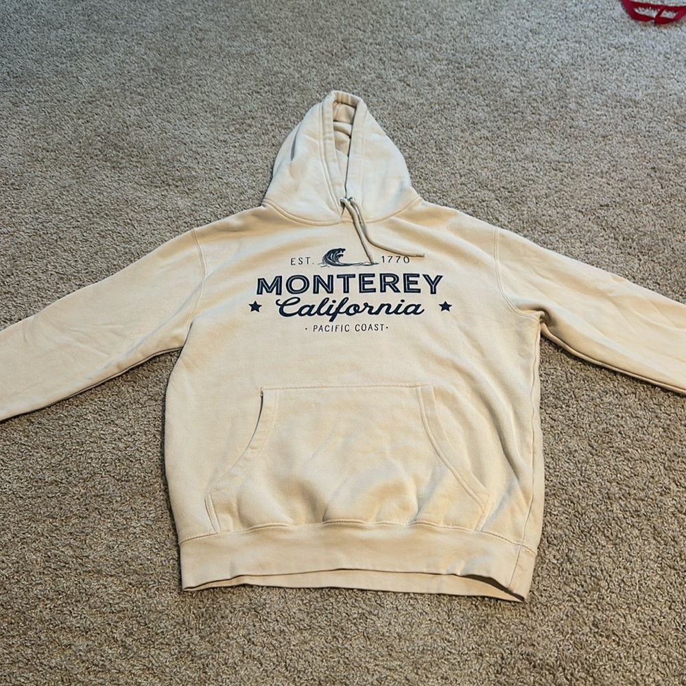 unisex cream hoodie, no size. possibly small or medium.